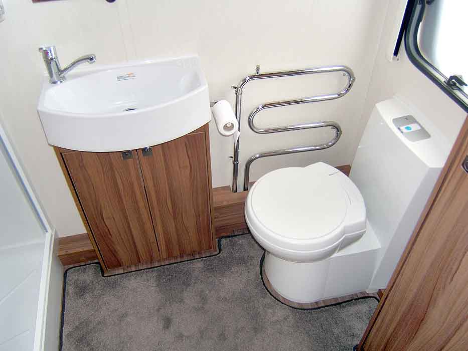 The washroom - showing washbasin, cassette toilet and heated towel rail.